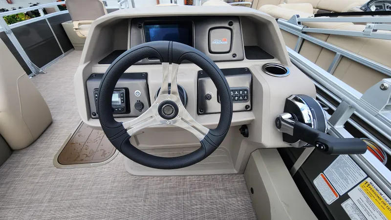 Slide: The Image of 2024 Sun Tracker Fishin' Barge 22 XP3 steering console with modern controls and dashboard. - 15
