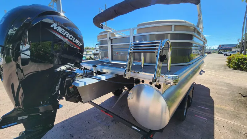 Slide: The Image of 2024 Sun Tracker Fishin' Barge 22 XP3 pontoon boat with Mercury outboard engine. - 2