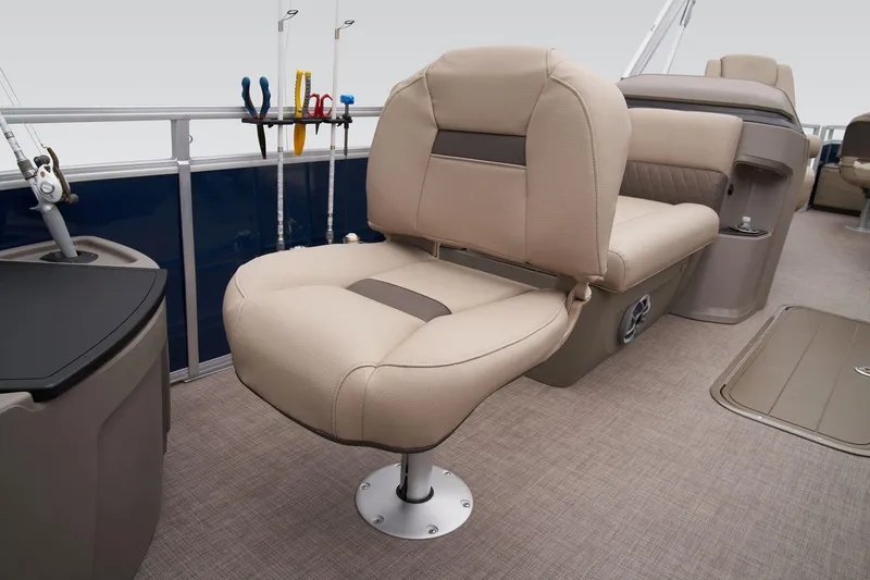 Slide: The Image of 2024 Sun Tracker Fishin' Barge 22 XP3 interior with beige seating and fishing rod holders. - 36
