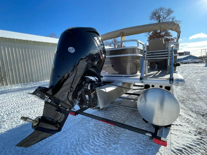 Slide: The Image of 2024 Sun Tracker SportFish 20 DLX pontoon boat with Mercury outboard engine on snowy ground. - 3