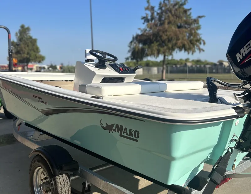 Slide: The Image of 2024 Mako Pro Skiff 13 CC boat on trailer, side view. - 1