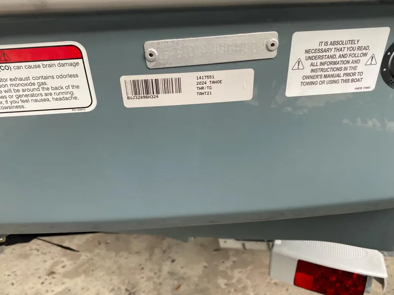 Slide: The Image of 2024 Tahoe T21 boat with safety and information labels on the hull. - 10
