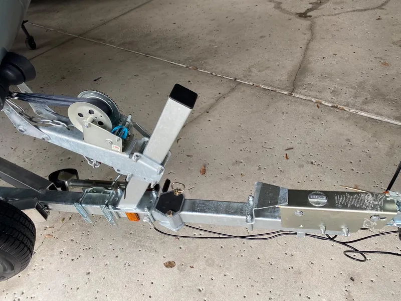 Slide: The Image of 2024 Tahoe T21 boat trailer hitch and winch system on concrete surface. - 11