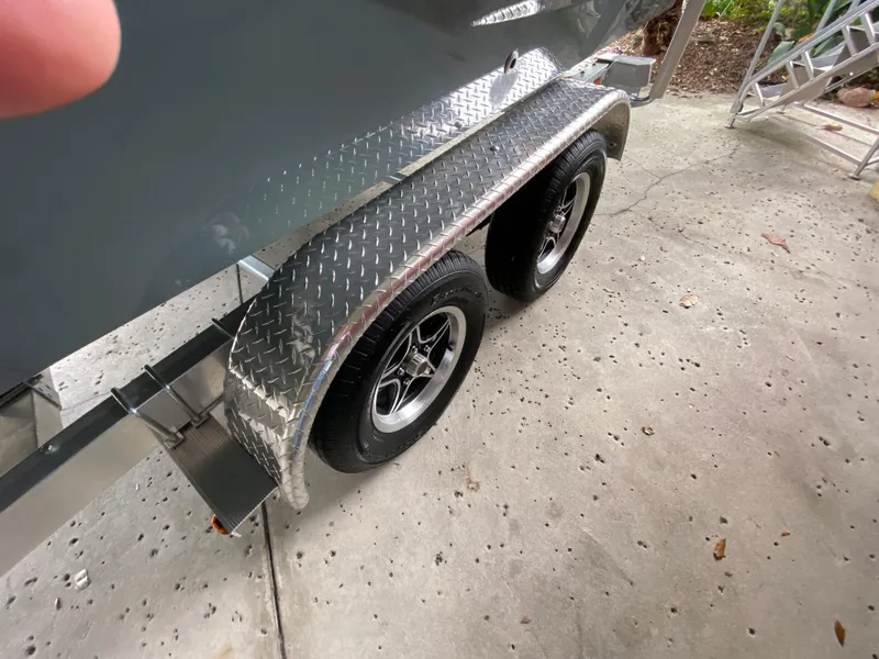 Slide: The Image of 2024 Tahoe T21 boat trailer with dual wheels and diamond plate fenders. - 2