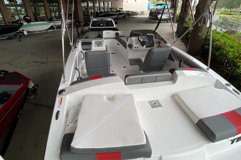 Slide: The Image of 2024 Tahoe T21 boat interior with seating and steering console. - 6
