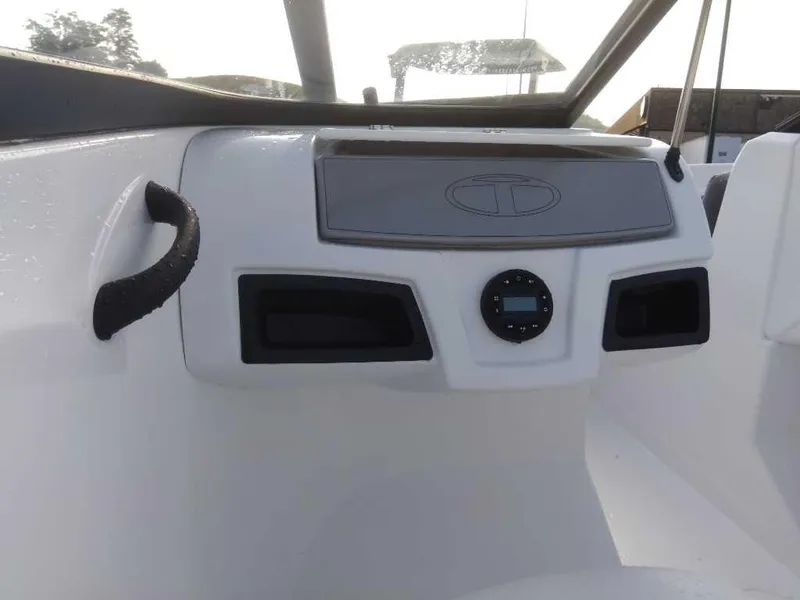 Slide: The Image of 2024 Tahoe 185 S boat dashboard with control panel and storage compartments. - 7