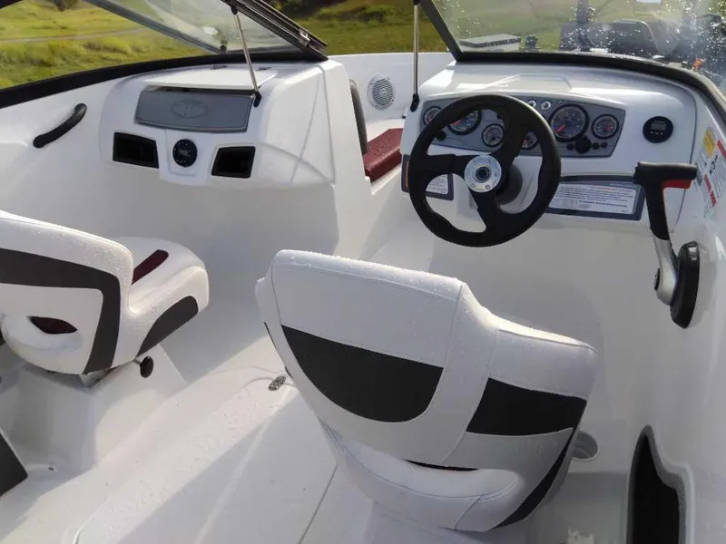Slide: The Image of 2024 Tahoe 185 S boat interior with steering wheel and seating. - 9