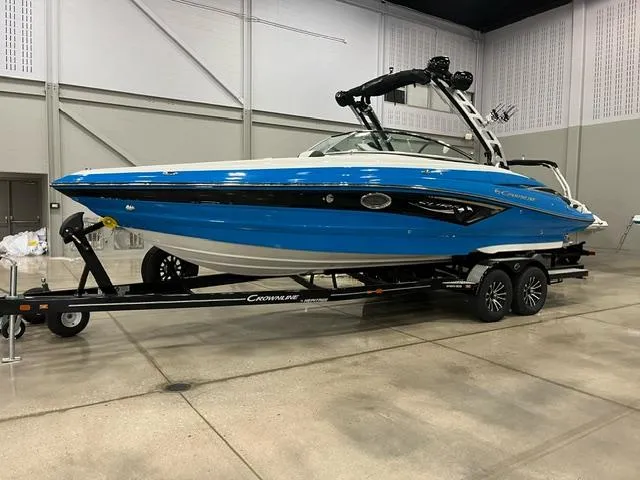 Slide: The Image of 2024 Crownline 280 SS boat on a trailer in an indoor showroom. - 0