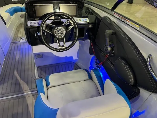 Slide: The Image of 2024 Crownline 280 SS boat cockpit with modern steering wheel and blue LED lighting. - 3