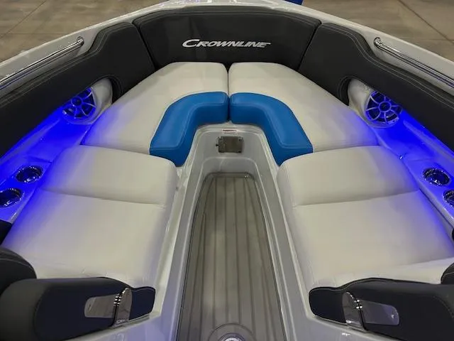 Slide: The Image of 2024 Crownline 280 SS boat interior with blue LED lighting and white cushioned seating. - 4