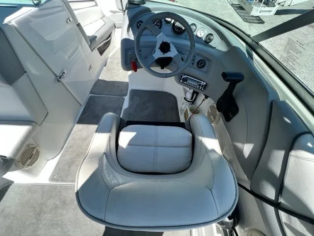 Slide: The Image of 2001 Cobalt 190 boat interior, featuring steering wheel and captain's chair. - 12