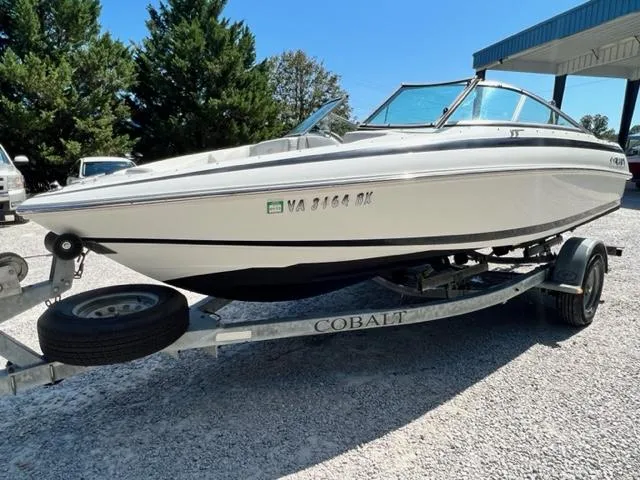 Slide: The Image of 2001 Cobalt 190 boat on a trailer in a parking lot. - 2