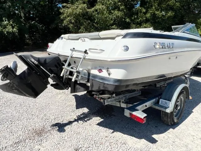 Slide: The Image of 2001 Cobalt 190 boat on trailer, rear view, parked on gravel. - 5
