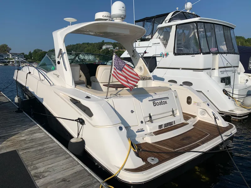Slide: The Image of 2012 Sea Ray Sundancer 370 yacht docked with US flag. - 16