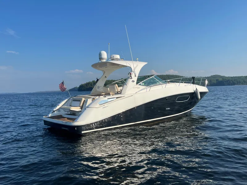 Slide: The Image of 2012 Sea Ray Sundancer 370 on calm water under clear sky. - 3