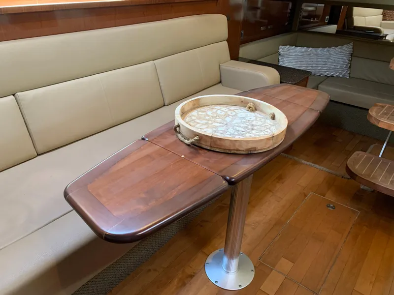 Slide: The Image of Sea Ray Sundancer 370 yacht interior, wooden table and leather sofa. - 33