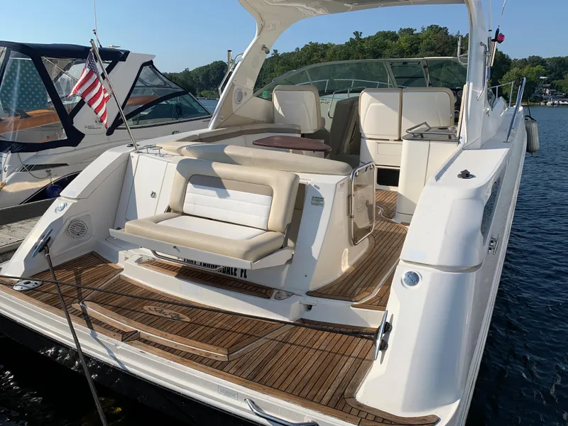 Slide: The Image of 2012 Sea Ray Sundancer 370 yacht with wooden deck by the water. - 46