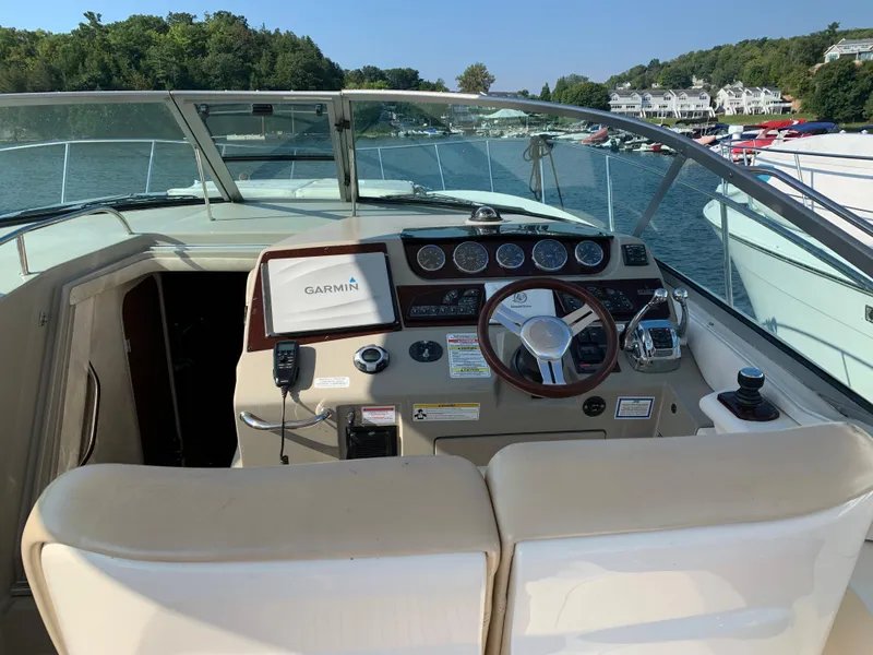 Slide: The Image of Interior view of a 2012 Sea Ray Sundancer 370 cockpit on the water. - 47
