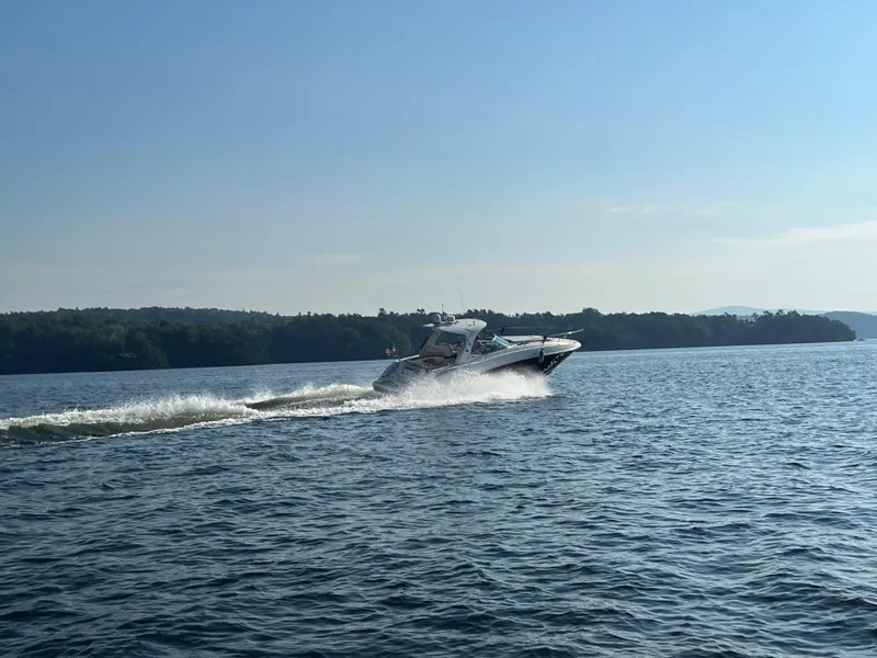 Slide: The Image of 2012 Sea Ray Sundancer 370 cruising on a serene lake. - 9