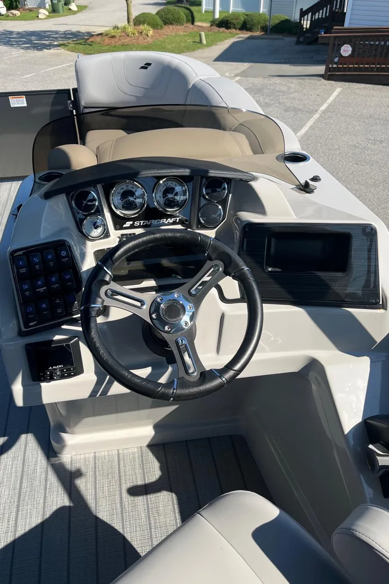 Slide: The Image of 2024 Starcraft SLS 3 Q DH boat dashboard with steering wheel and control panel. - 11