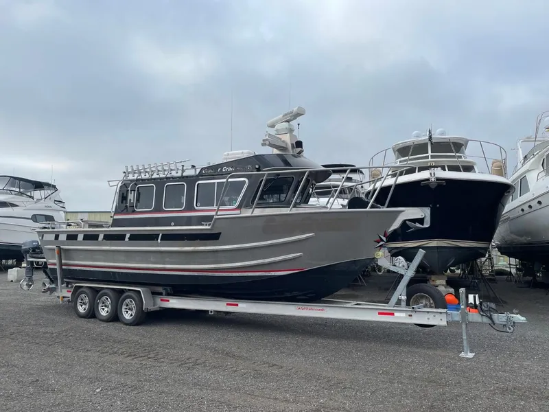 The Image of 2010 Glacier Craft Custom Aluminum boat on a trailer in a marina. - 1