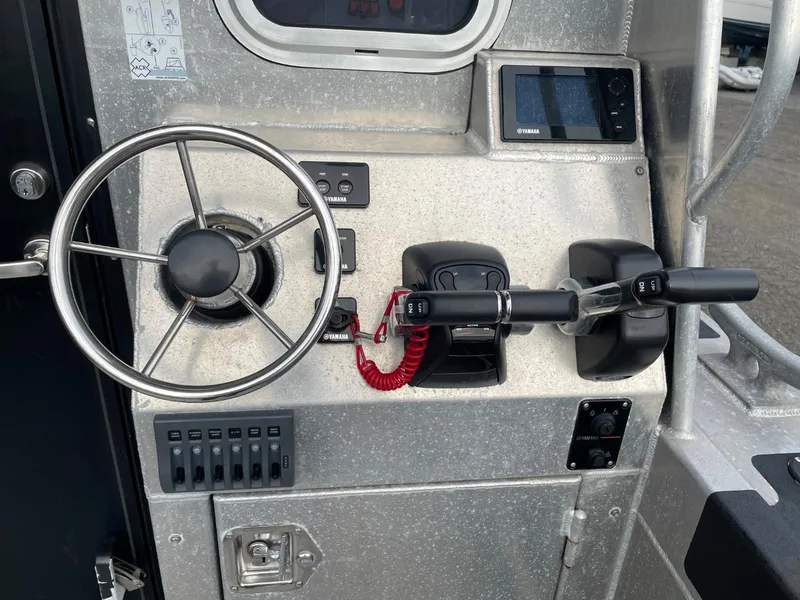 Slide: The Image of Control panel of a 2010 Glacier Craft Custom Aluminum boat with steering wheel and throttle. - 14