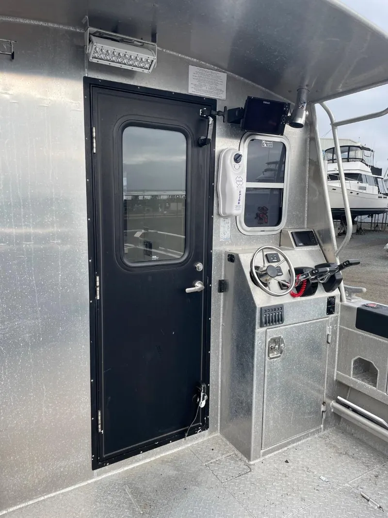 Slide: The Image of 2010 Glacier Craft Custom Aluminum boat cockpit with steering wheel and control panel. - 26