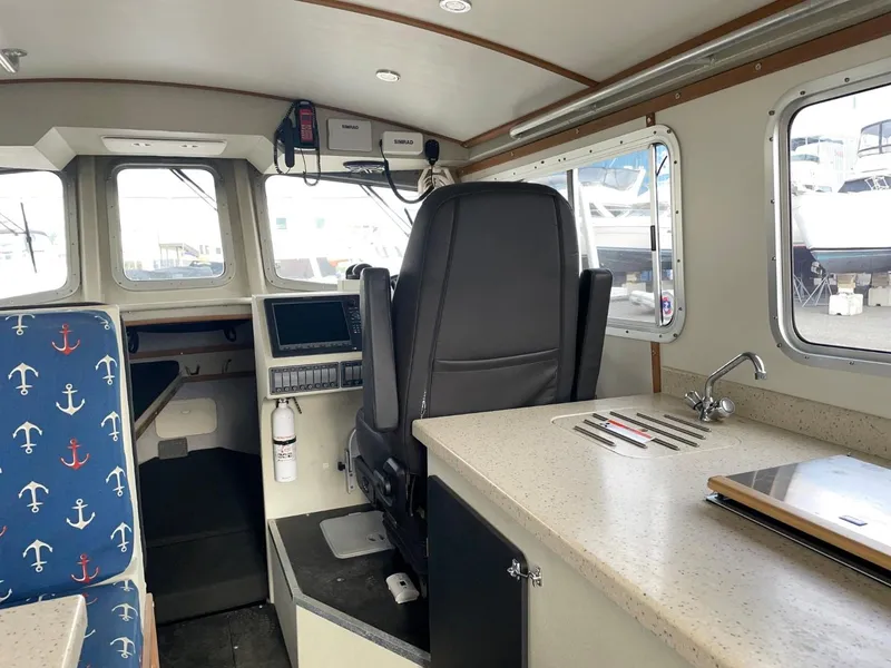 Slide: The Image of Interior of a 2010 Glacier Craft Custom Aluminum boat with helm and seating area. - 30