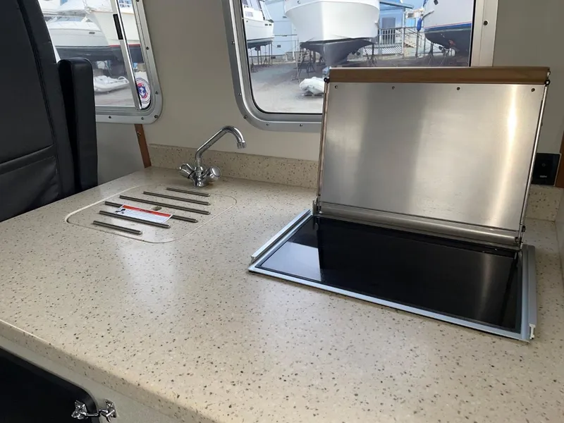 Slide: The Image of 2010 Glacier Craft Custom Aluminum boat interior kitchen with sink and stove. - 32