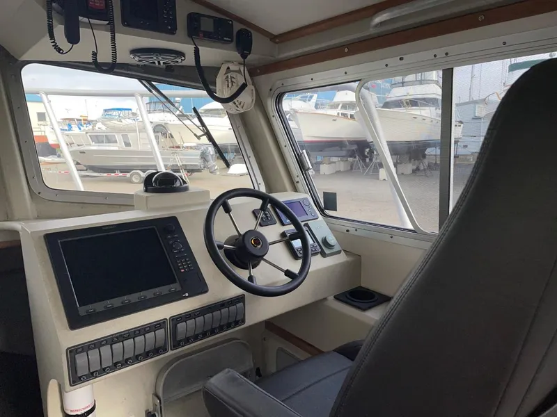 Slide: The Image of Interior of 2010 Glacier Craft Custom Aluminum boat with steering wheel and control panel. - 36