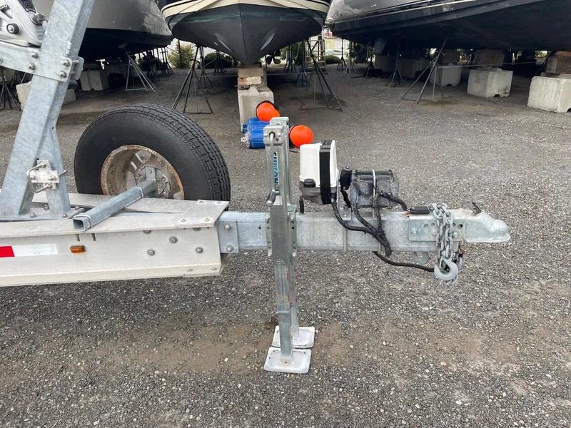 Slide: The Image of 2010 Glacier Craft Custom Aluminum boat trailer hitch and jack stand in a boatyard. - 4