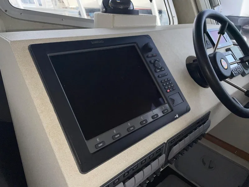 Slide: The Image of 2010 Glacier Craft Custom Aluminum boat dashboard with navigation system and steering wheel. - 40
