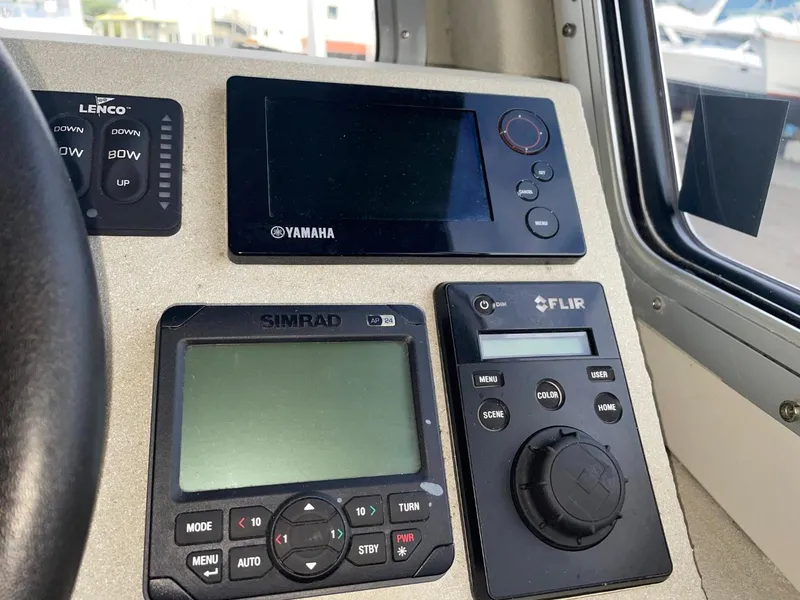 Slide: The Image of Boat control panel with Yamaha, Simrad, and FLIR displays on a 2010 Glacier Craft Custom Aluminum. - 43