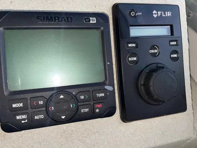 Slide: The Image of Simrad and FLIR navigation and control panels on a 2010 Glacier Craft Custom Aluminum boat. - 48