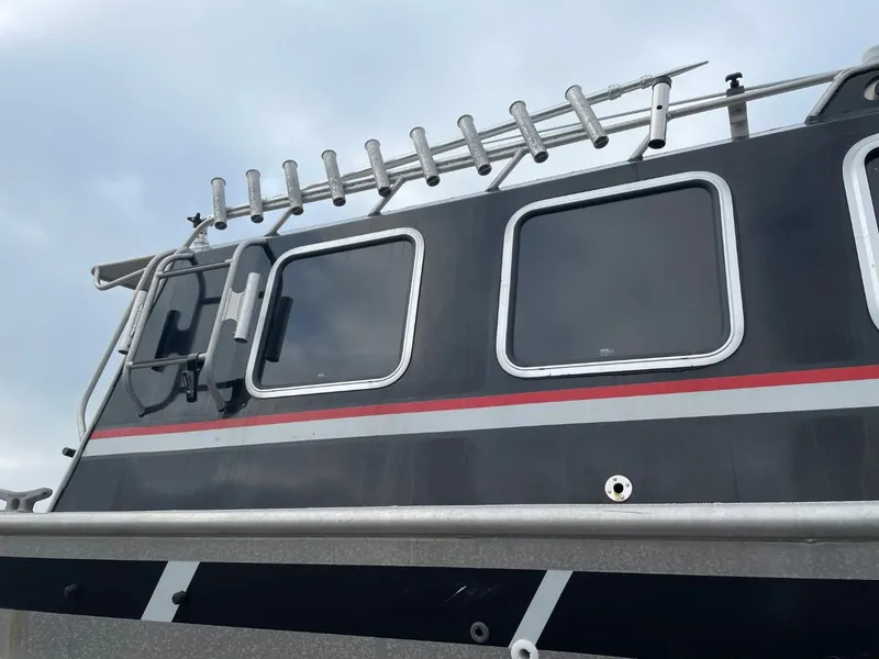 Slide: The Image of 2010 Glacier Craft Custom Aluminum boat with rod holders and windows. - 6