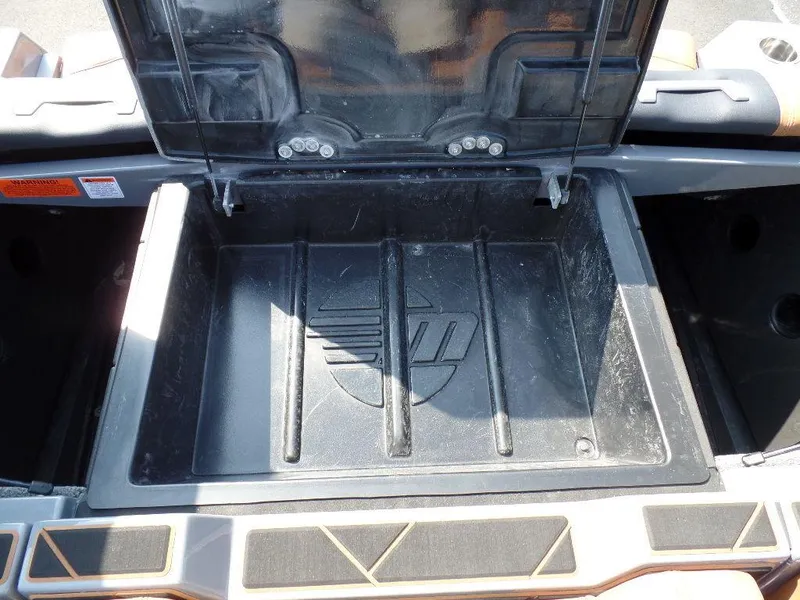 Slide: The Image of Open storage compartment in a 2023 Malibu 26 LSV boat. - 16