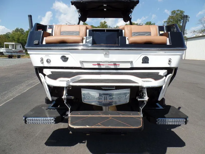 Slide: The Image of 2023 Malibu 26 LSV boat rear view with swim platform and seating. - 4