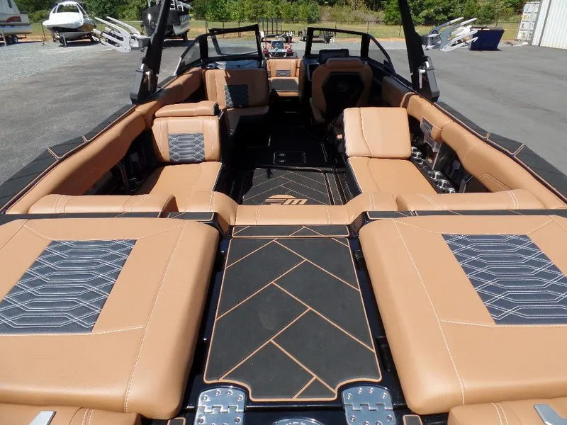 Slide: The Image of 2023 Malibu 26 LSV boat interior with tan leather seating and sleek design. - 5