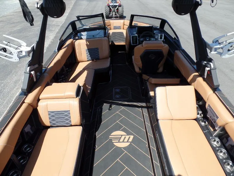 Slide: The Image of 2023 Malibu 26 LSV boat interior with tan seating and modern design. - 6