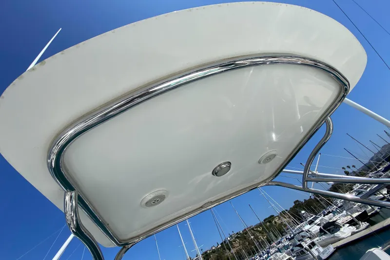 Slide: The Image of 2005 Cabo 40 Hardtop Express boat roof with chrome details against a clear blue sky. - 10