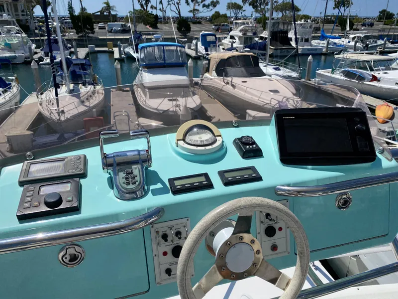 Slide: The Image of Helm of 2005 Cabo 40 Hardtop Express yacht with navigation equipment, docked at marina. - 11
