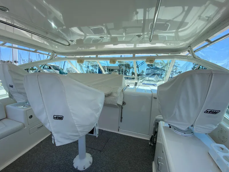 Slide: The Image of 2005 Cabo 40 Hardtop Express interior with covered seats and panoramic windows. - 16