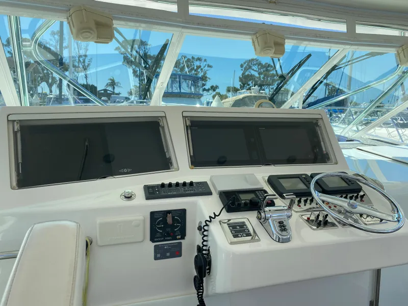 Slide: The Image of Control panel of a 2005 Cabo 40 Hardtop Express boat with navigation screens. - 17