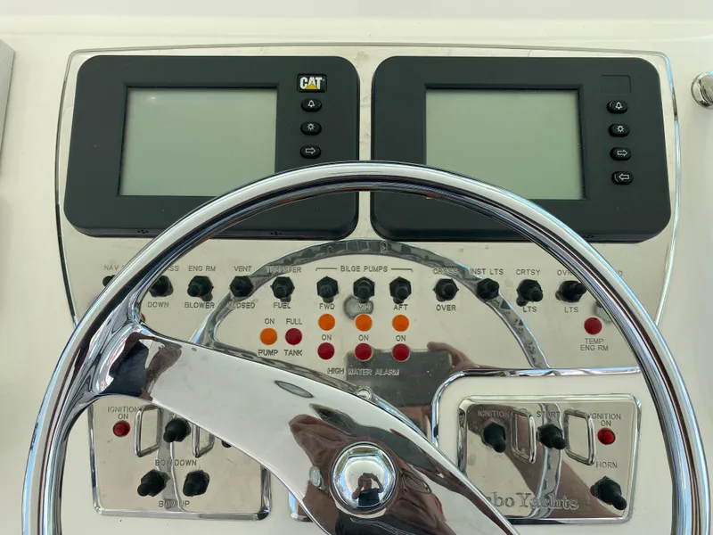 Slide: The Image of Control panel of a 2005 Cabo 40 Hardtop Express boat with steering wheel. - 20
