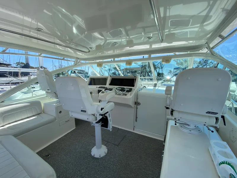 Slide: The Image of 2005 Cabo 40 Hardtop Express boat interior with helm, seating, and navigation equipment. - 23
