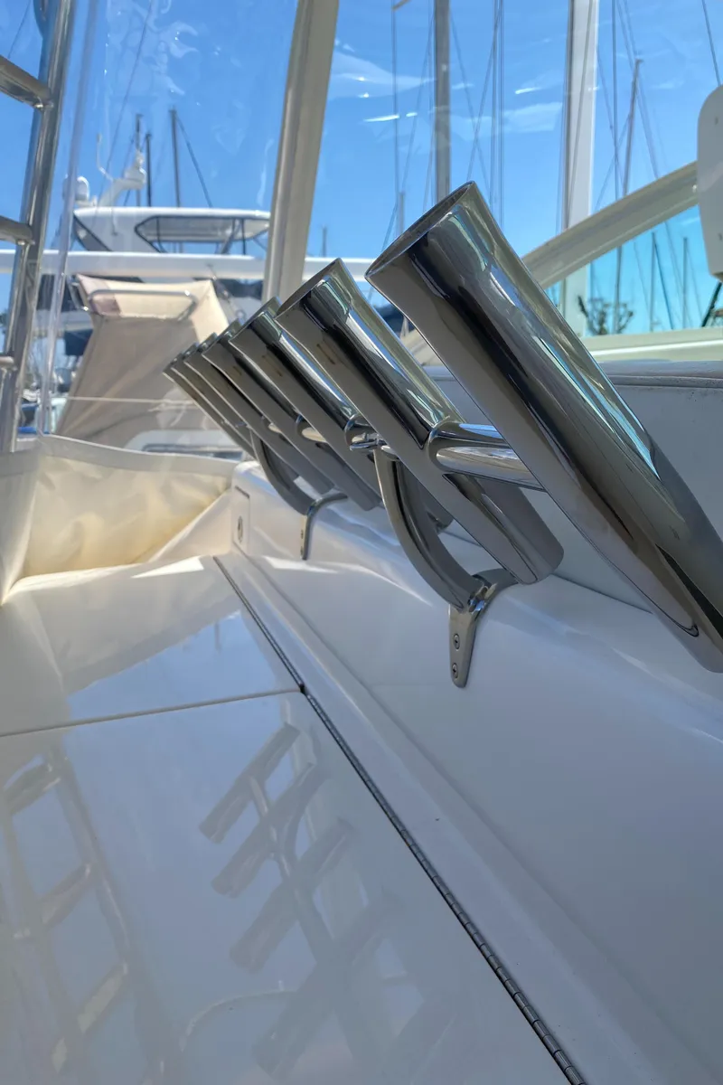 Slide: The Image of 2005 Cabo 40 Hardtop Express boat with stainless steel rod holders. - 29
