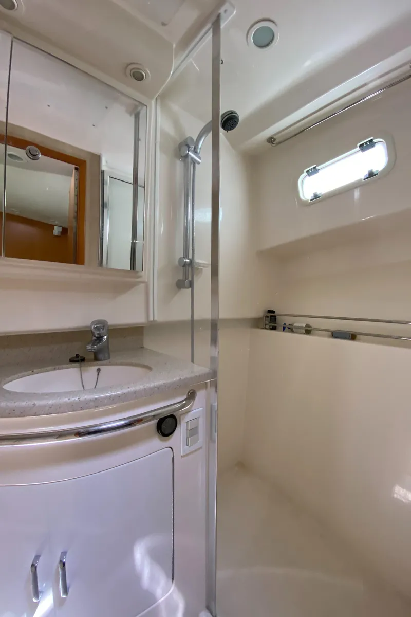 Slide: The Image of 2005 Cabo 40 Hardtop Express yacht bathroom with shower and sink. - 34