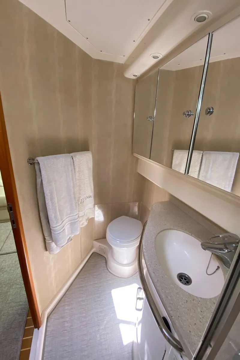 Slide: The Image of 2005 Cabo 40 Hardtop Express bathroom with sink, toilet, and towel rack. - 35