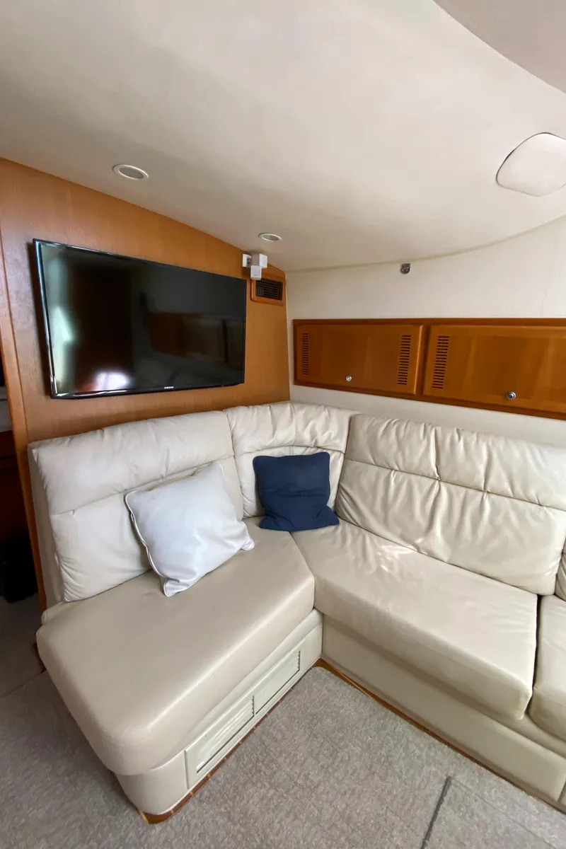 Slide: The Image of Interior of 2005 Cabo 40 Hardtop Express with leather seating and wall-mounted TV. - 36