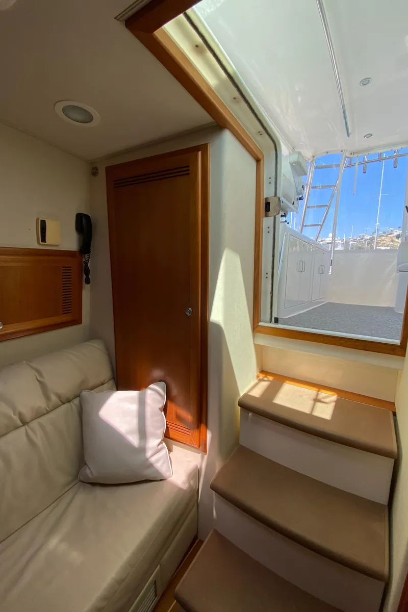Slide: The Image of Interior view of 2005 Cabo 40 Hardtop Express yacht with stairs and seating area. - 37